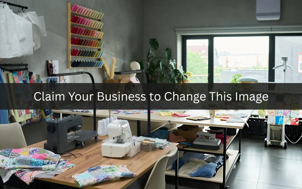 Professional tailor shop interior with sewing machines and clothing alterations workspace